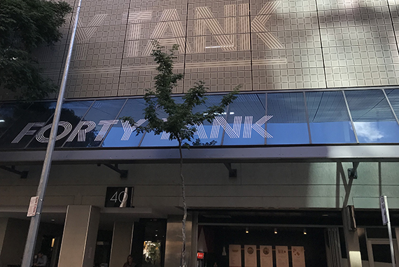 Forty Tank Store front covered by tree branches in city building